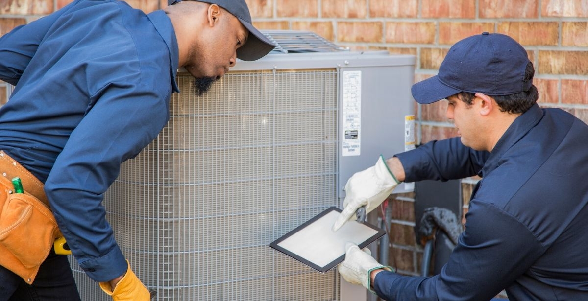 HVAC technicians with air conditioner